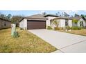 House exterior showcasing a driveway and two-car garage at 1856 Red Loop, Lakeland, FL 33801