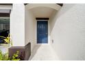 Modern front door with a covered entryway and concrete walkway at 1856 Red Loop, Lakeland, FL 33801