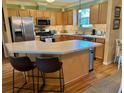 Spacious kitchen with an island and stainless steel appliances at 457 Enright Pl, The Villages, FL 32162