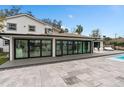 Spacious tiled patio with folding glass doors, a pool, and comfortable outdoor seating at 301 Rippling Ln, Winter Park, FL 32789