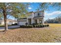 Two-story house with a large front yard and attached garage at 2016 Sanderlin Point Loop, Apopka, FL 32703