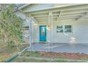 Charming front porch with teal door and decorative metal railings at 270 N 1St St, Lake Mary, FL 32746