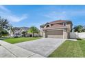 House exterior showcasing a large driveway and front yard at 11924 Pethrick Dr, Orlando, FL 32824