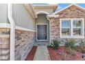 Inviting front entry with stonework and a modern door at 1320 Se 63Rd Court Rd, Ocala, FL 34472