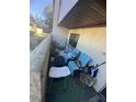 Small patio with teal chairs and various items at 1880 N Crystal Lake Dr # 57, Lakeland, FL 33801