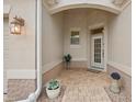 Inviting front entry with a tiled walkway and potted plants at 461 Troy Loop, The Villages, FL 32162