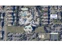 An aerial view of a home near a waterpark, clubhouse, and tennis court, showcasing its prime location at 220 Clawson Way, Kissimmee, FL 34747