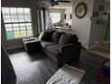 Living room with grey sectional sofa and lake view at 1065 S Hiawassee Rd # 1416, Orlando, FL 32835