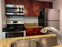 Modern kitchen with stainless steel appliances and granite countertops at 5124 Conroy Rd # 27, Orlando, FL 32811