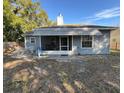 Home features a screened porch and a spacious backyard at 305 Pinecrest Rd, Mount Dora, FL 32757