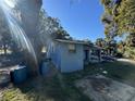 Side view of blue house showing roof damage at 216 N Salem St, Eustis, FL 32726