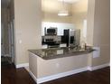 Modern condo kitchen featuring granite countertops and stainless steel appliances at 705 Celebration Ave # 705, Celebration, FL 34747