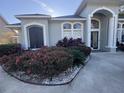 Landscaped front yard with flowering bushes and stone features at 1150 Sweet Heather Ln, Apopka, FL 32712