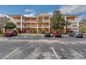 Wide exterior view of a multi-unit residential building showcasing ample parking and well-maintained landscaping at 301 New Providence Promenade, Davenport, FL 33897