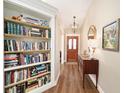 Welcoming foyer with hardwood floors, built-in bookcase, and access to other rooms at 4503 Se 14Th St, Ocala, FL 34471