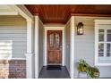 Elegant front entryway features a stained wood door with decorative glass and a covered porch at 4503 Se 14Th St, Ocala, FL 34471