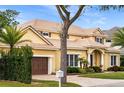 Beautiful two-story home with manicured lawn, mature landscaping, barrel tile roof and a two car garage at 889 Brantley Dr, Longwood, FL 32779