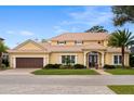 Charming two-story home with a barrel tile roof, manicured lawn, beautiful landscaping and a two car garage at 889 Brantley Dr, Longwood, FL 32779