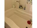 Relaxing soaking tub with tile surround and convenient built-in shelving at 860 N Orange Ave # 258, Orlando, FL 32801