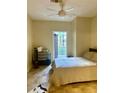 Comfortable bedroom with a king bed, ceiling fan, and a door to the outdoor balcony at 860 N Orange Ave # 258, Orlando, FL 32801