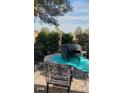 Small patio with table and chairs, overlooking a golf course at 13026 Se 97Th Terrace Rd, Summerfield, FL 34491