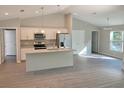 Open concept kitchen with an island, stainless steel appliances, and light-colored cabinetry at 6435 Sw 204 Ave, Dunnellon, FL 34431