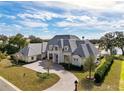 Expansive home with circular driveway, a large manicured front lawn, and mature landscaping at 8570 Nw 31St Lane Rd, Ocala, FL 34482