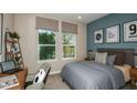Cozy bedroom with natural light, a comfortable bed, and stylish decor creating a relaxing atmosphere at 2136 Babbling Brook Blvd, Auburndale, FL 33823