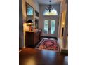 Inviting foyer with elegant chandelier, hardwood floors, and a decorative rug at 4622 Warrington Dr, Orlando, FL 32826