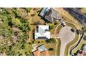 An aerial view of the property showcasing its backyard, solar panels, and proximity to the lake at 603 Pinehurst Ct, Kissimmee, FL 34758