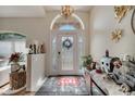 Bright foyer with tile flooring, decorative front door, and high ceilings, leading into the home at 603 Pinehurst Ct, Kissimmee, FL 34758