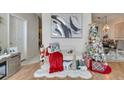 Inviting living room with hardwood floors, decorated for the holidays, and ample natural light at 603 Pinehurst Ct, Kissimmee, FL 34758