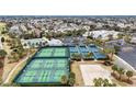 Aerial view of community amenities with tennis courts, pickleball courts and a sand volleyball court at 2378 Ridgeway Ct, The Villages, FL 32162
