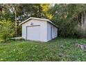 Exterior shot of the detached single car garage with white paint and a concrete foundation at 103 S Flagler Ave, Edgewater, FL 32132