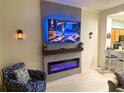 Modern living room features a fireplace, mounted TV, and tile flooring at 13427 Blue Heron Beach Dr # 2106, Orlando, FL 32821