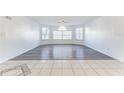 Bright living room with tile and wood flooring and multiple windows allowing ample natural light to enter at 2735 N Poinciana Blvd # 103, Kissimmee, FL 34746