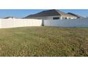 Large, fenced backyard with a spacious lawn at 357 Summershore Dr, Auburndale, FL 33823