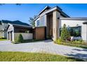 Beautiful modern two-story home with manicured landscaping and an inviting, paved driveway and walkway at 1691 Chestnut Ave, Winter Park, FL 32789