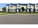 A row of townhomes with tidy landscaping, sidewalks, and well-maintained facades offer an inviting curb appeal at 3842 Knotty Pine St, St Cloud, FL 34772