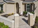 Inviting front porch with seating area, featuring detailed architectural accents and landscape at 584 Aldenham Ln, Ormond Beach, FL 32174