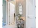 Hallway with white doors, and decorated side table at 584 Aldenham Ln, Ormond Beach, FL 32174