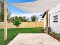 A nicely landscaped backyard with a shade sail and tropical plants at 748 Neuse Ave, Orlando, FL 32804