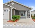 Exterior view showcasing the home's screened-in porch and tidy landscaping at 3575 Cochran St, The Villages, FL 32163
