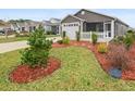 Street view of a well-maintained home with vibrant landscaping and a white picket fence at 3575 Cochran St, The Villages, FL 32163
