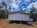 A house under construction shows a house with its walls covered with underlayment at 10129 Sw 157Th Ln, Dunnellon, FL 34432