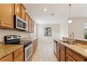 Functional kitchen with granite countertops, stainless steel appliances, and natural light at 1086 Harmony Ln, Clermont, FL 34711