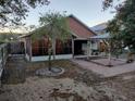 View of screened-in porch and brick patio in backyard with mature trees and shrubs at 30126 Sandbunker Ln, Sorrento, FL 32776