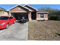 Inviting home with a convenient driveway, attached garage, and tidy landscaping at 30126 Sandbunker Ln, Sorrento, FL 32776