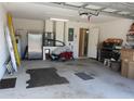 Spacious garage interior with storage and access to the house, offering practical utility at 30126 Sandbunker Ln, Sorrento, FL 32776