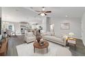 Bright, open-concept living room with a modern kitchen and stylish furnishings offers a welcoming atmosphere at 20184 Sw 57 St, Dunnellon, FL 34431